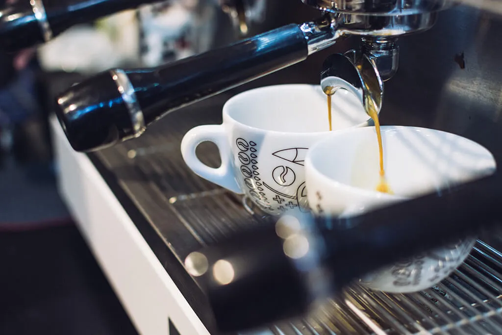 Espresso läuft aus einer Siebträgermaschine in eine Tasse